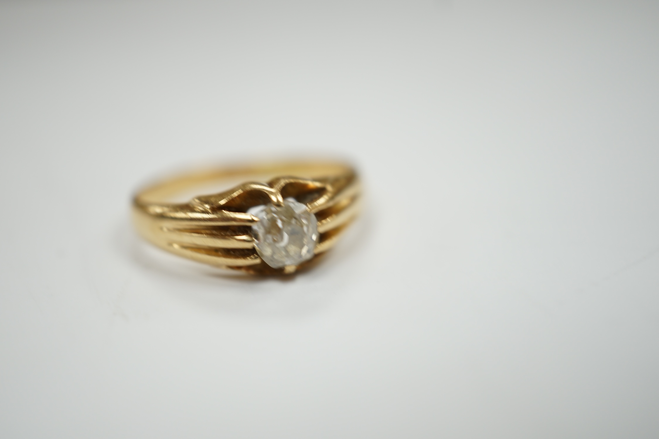 An 18ct gold and claw set solitaire diamond ring, size L, gross weight 3.5 grams.